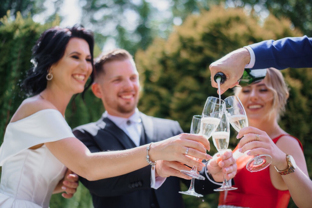 smiled wedding couple with best friends are drinking champagne outdoors smiling 1024x683 1